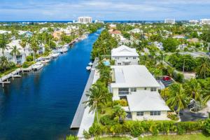 an aerial view of a canal with houses and palm trees at Snug Harbour View Condo #6 in George Town