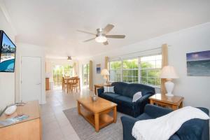 a living room with a blue couch and a table at Snug Harbour View Condo #6 in George Town +49 photos