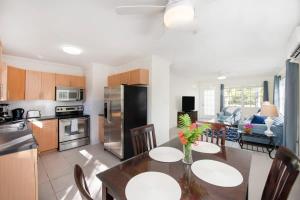 a kitchen and dining room with a table and chairs at Snug Harbour View Condo #1 in George Town