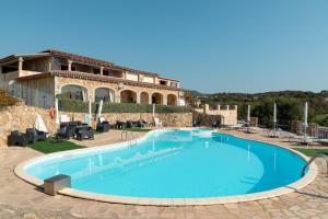 a large swimming pool in front of a building at Casa Marià by Wonderful Italy in Olbia