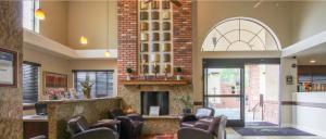 a waiting room with chairs and a fireplace at GreenTree Inn Flagstaff in Flagstaff