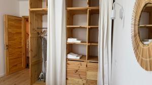 a closet with wooden shelves and a door at Затишне місце біля парку in Kyiv