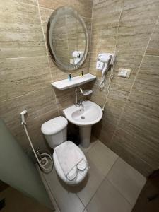 a bathroom with a sink and a toilet and a mirror at Osiris pyramids in Cairo +102 photos