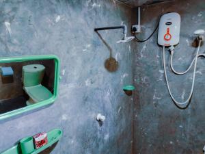 a bathroom with a shower and a mirror at Little Cabanas Udawalawe in Udawalawe