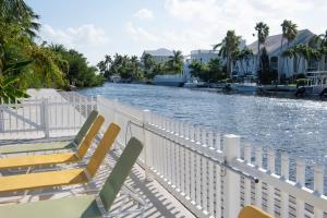 a group of chairs sitting on the side of a river at Snug Harbour View Condo #4 in George Town
