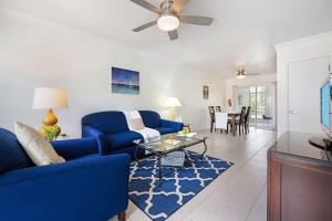a living room with a blue couch and a table at Snug Harbour View Condo #2 in George Town