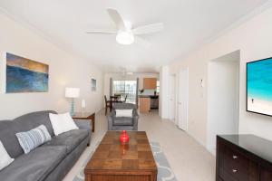 a living room with a couch and a table at Snug Harbour View Condo #9 in George Town