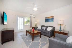 a living room with a couch and a table at Snug Harbour View Condo #9 in George Town +50 photos