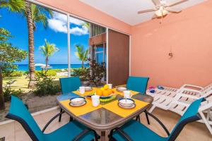 a dining room with a table and chairs and the ocean at Northern Lights #4 Condo in Old Man Bay +63 photos