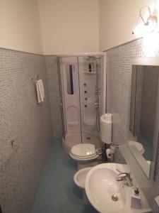 a bathroom with a sink and a toilet and a shower at Sky Sleeping in Palermo