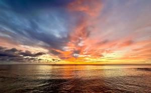 ジョージ・タウンにあるCocoplum #5 Condoの曇り空と海上の夕日