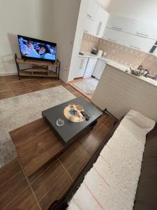 a living room with a table and a tv at abi home in Ulcinj