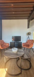 a living room with a table and two chairs at Appartement en centre ville in Bernay