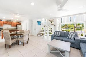 a living room with a couch and a table at Island House #12 at Rum Point in Driftwood Village