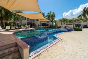a swimming pool in the middle of a resort at Colonial Kai Condo in Driftwood Village +41 photos