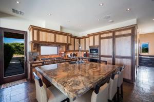 a large kitchen with a large marble counter top at Stepping Stone 4 BR East End in Sand Bluff