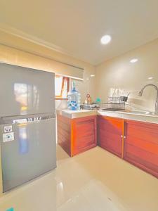 a kitchen with a stainless steel refrigerator and a sink at Rustic Loft Bungalow in Jimbaran in Jimbaran +24 photos