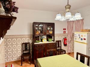 a kitchen with a refrigerator and a table with chairs at Casa da Tia Julia in Avis