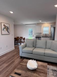 a living room with a couch and a kitchen at Chic Beach Home Near Airport Casino Coliseum Base in Gulfport +46 photos