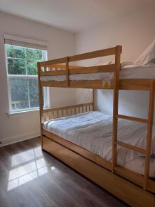 a bedroom with two bunk beds and a window at Chic Beach Home Near Airport Casino Base in Gulfport