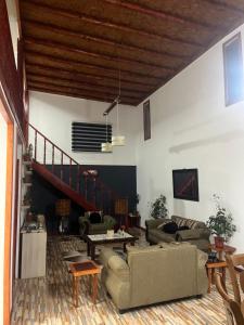 a living room with two couches and a staircase at El Relajo de Santa Cruz in Estación Colchagua
