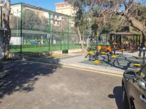 a bus stop with a playground in a park at nizami m hostel in Baku