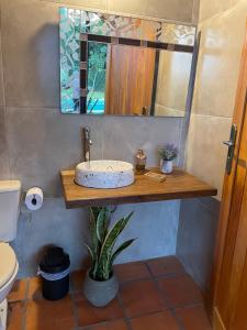 a bathroom with a sink and a mirror at Colonial Style House in Villarrica +30 photos