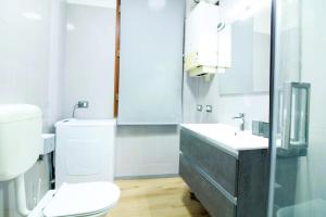 a white bathroom with a toilet and a sink at Argenta Center every comfort in Argenta +19 photos