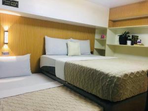 a bedroom with two beds in a room at Loft2600 in Baguio +12 photos