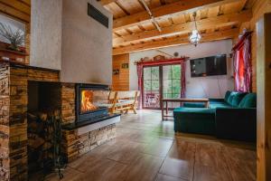 a living room with a couch and a fireplace at Drevenica u Kováčov in Nižná Boca