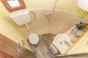 an overhead view of a bathroom with a toilet and a sink at Krka fairytale village in Skradin +40 photos