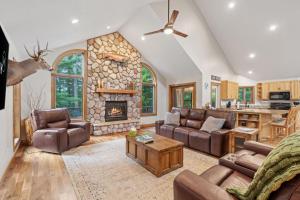 a large living room with a stone fireplace at Eagle Ridge in Menomonie