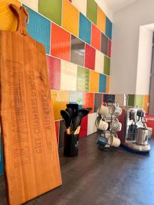 a wooden cutting board sitting on top of a kitchen counter at Gîte Le Patio Bleu in Saint-Romain
