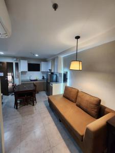 a living room with a couch and a table at 2F Vivere Condo - Govantes Properties in Vigan