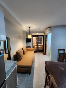 a living room with a couch and a table at 2F Vivere Condo - Govantes Properties in Vigan