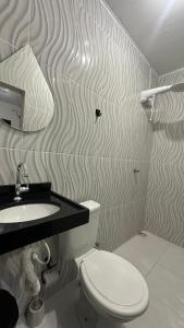 Ένα μπάνιο στο Aconchego Hospedagem