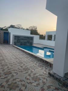 a house with a swimming pool and a tile floor at res Montesino in San Felipe de Puerto Plata +3 photos