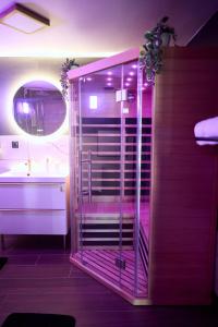 a bathroom with a glass shower and a sink at Romance House in Arnouville-lès-Gonesse