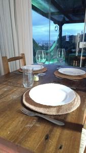 a wooden table with plates and glasses on it at casa para Oktoberfest in Blumenau