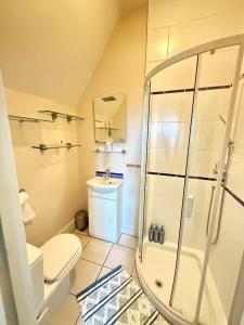 a bathroom with a shower and a toilet and a sink at 4 Bed Retreat-Sleeps 7-Parking-Garden-Lake Views in Bolton +22 photos