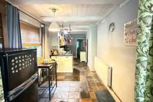 a kitchen with a counter and a table in a room at 4 Bed Retreat-Sleeps 7-Parking-Garden-Lake Views in Bolton