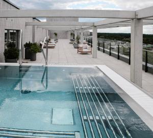 a swimming pool on the roof of a building at Pušų nata in Druskininkai