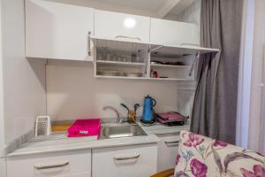 a small kitchen with white cabinets and a sink at Blue Diana hotels in Istanbul