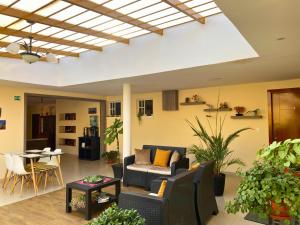 a living room with a couch and a table at Las Hortensia's Casa De Huespedes in Tababela +33 photos