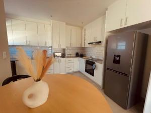 a kitchen with a table with a vase on it at Biz & Bliss Work & Serene Views in Windhoek