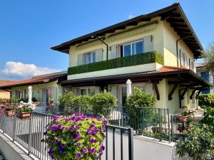 a house with flowers on a fence at Appartamenti Rossini in Bardolino