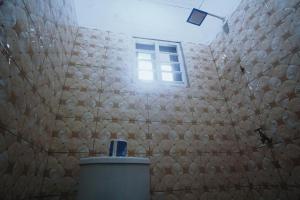 a bathroom with a stone wall with a window at Peaceful Apartments  +21 photos