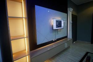 a large flat screen tv on a wall at Peaceful Apartments 