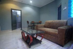 a living room with a couch and a glass table at Peaceful Apartments 