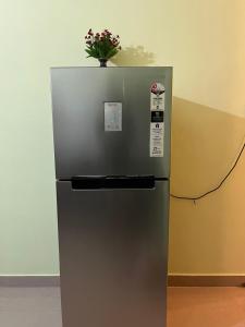 a refrigerator with a potted plant on top of it at Urban Aura 3bhk near Gs road in Guwahati